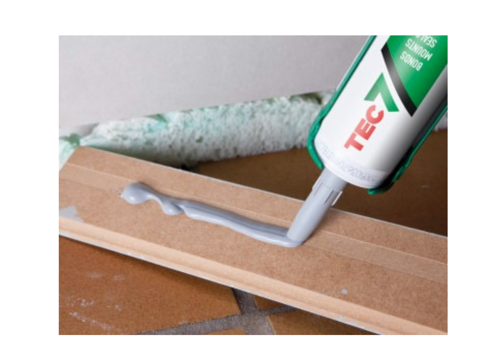 Applying Tec7 adhesive to skirting board